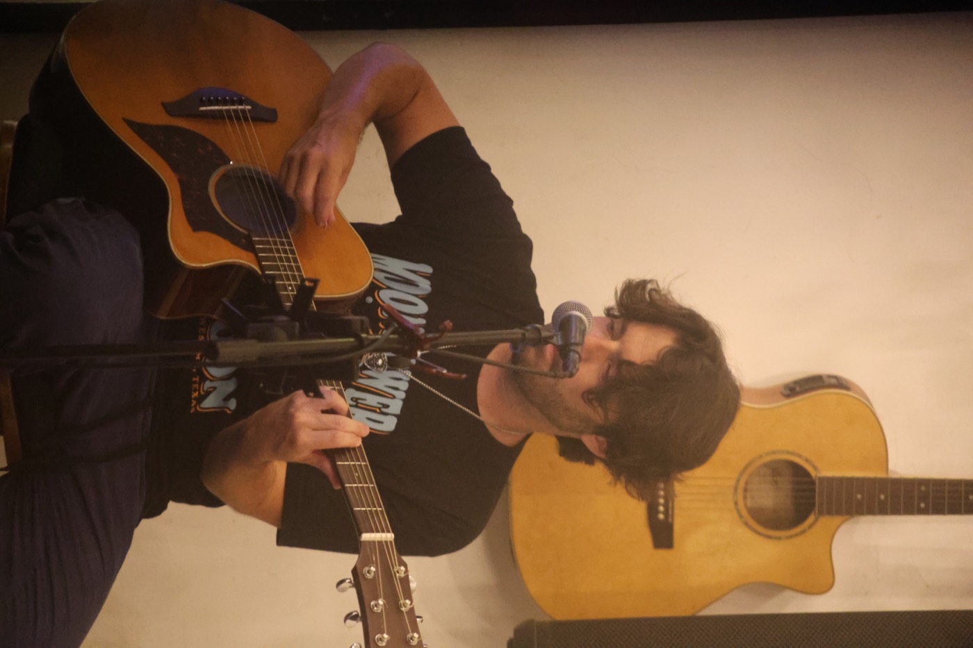 Stevie Matthews playing acoustic guitar and singing live at Baliwood in Canggu, Bali